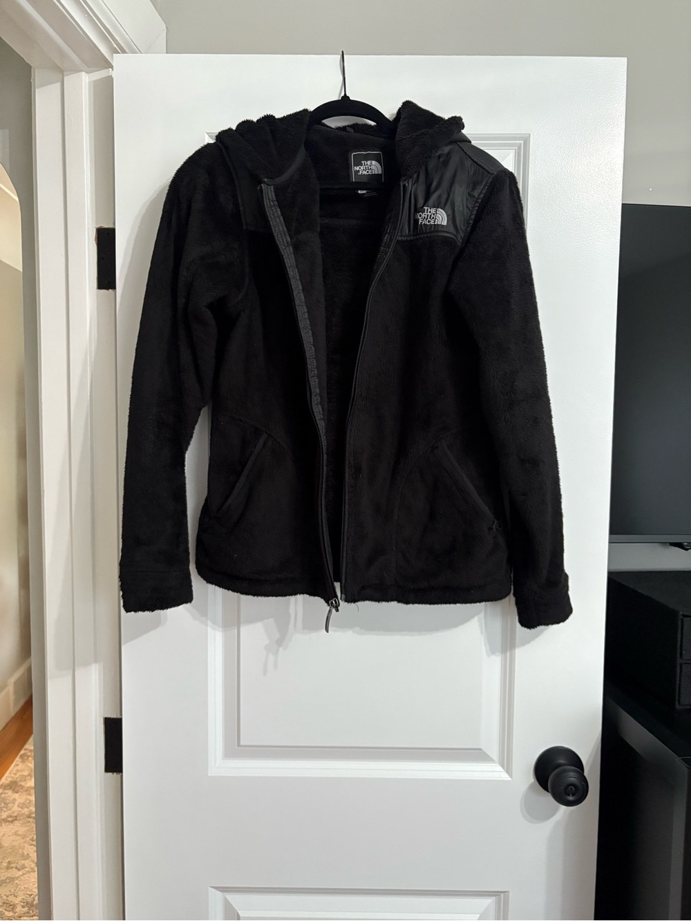 The North Face woman’s Black Hooded fleece Jacket